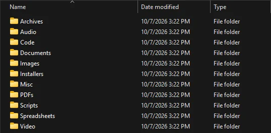 Windows File Explorer showing eleven category folders after sorting: Archives, Audio, Code, Documents, Images, Installers, Misc, PDFs, Scripts, Spreadsheets and Video.